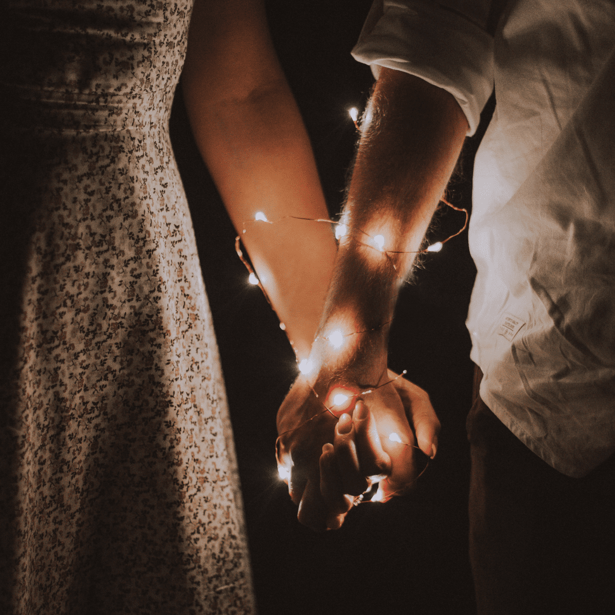 hand holding with fairy lights.
